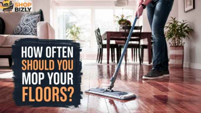 Homeowner using a microfiber mop to clean a hard floor in a modern home.